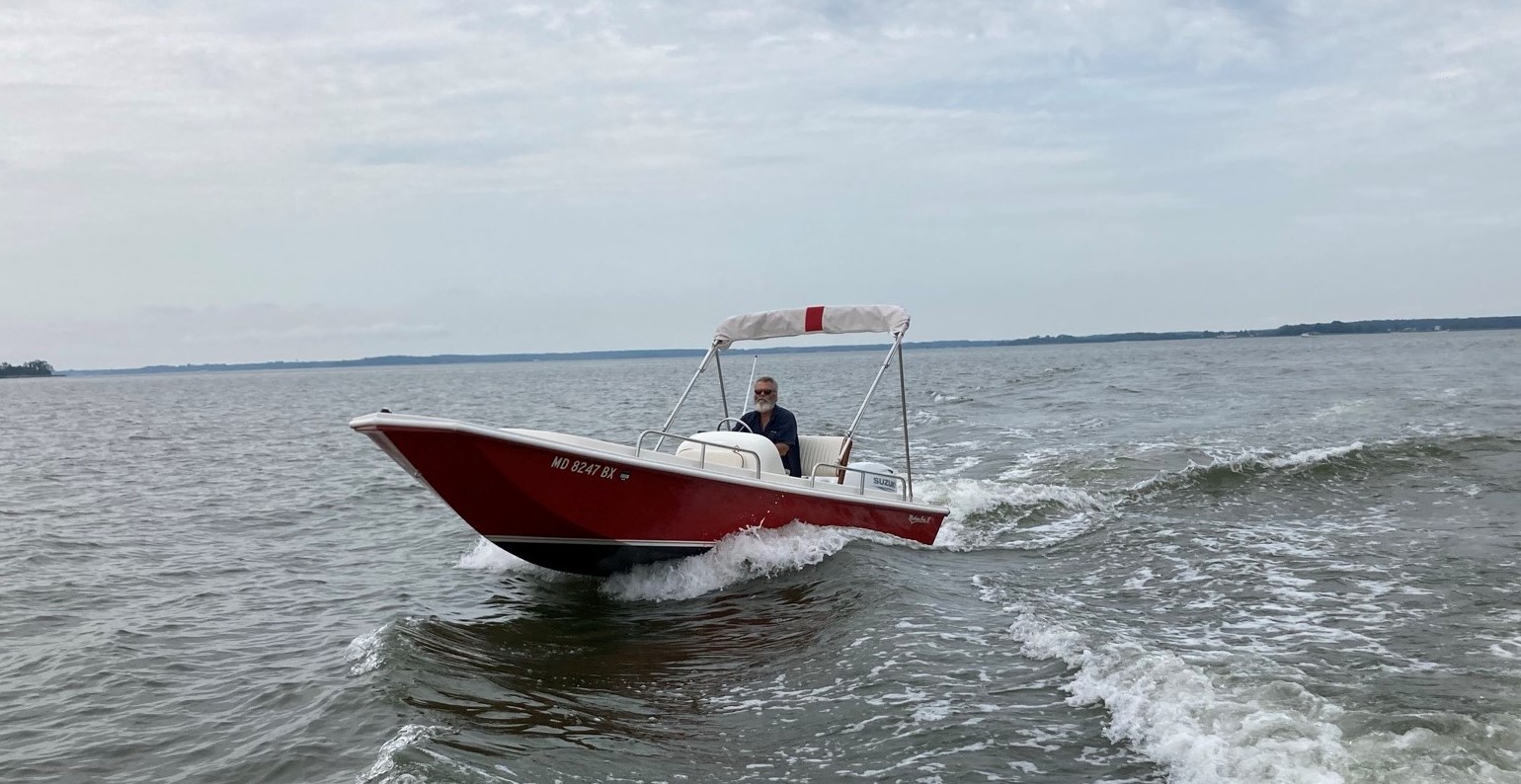 A red boat with a wooden crabbing skiff